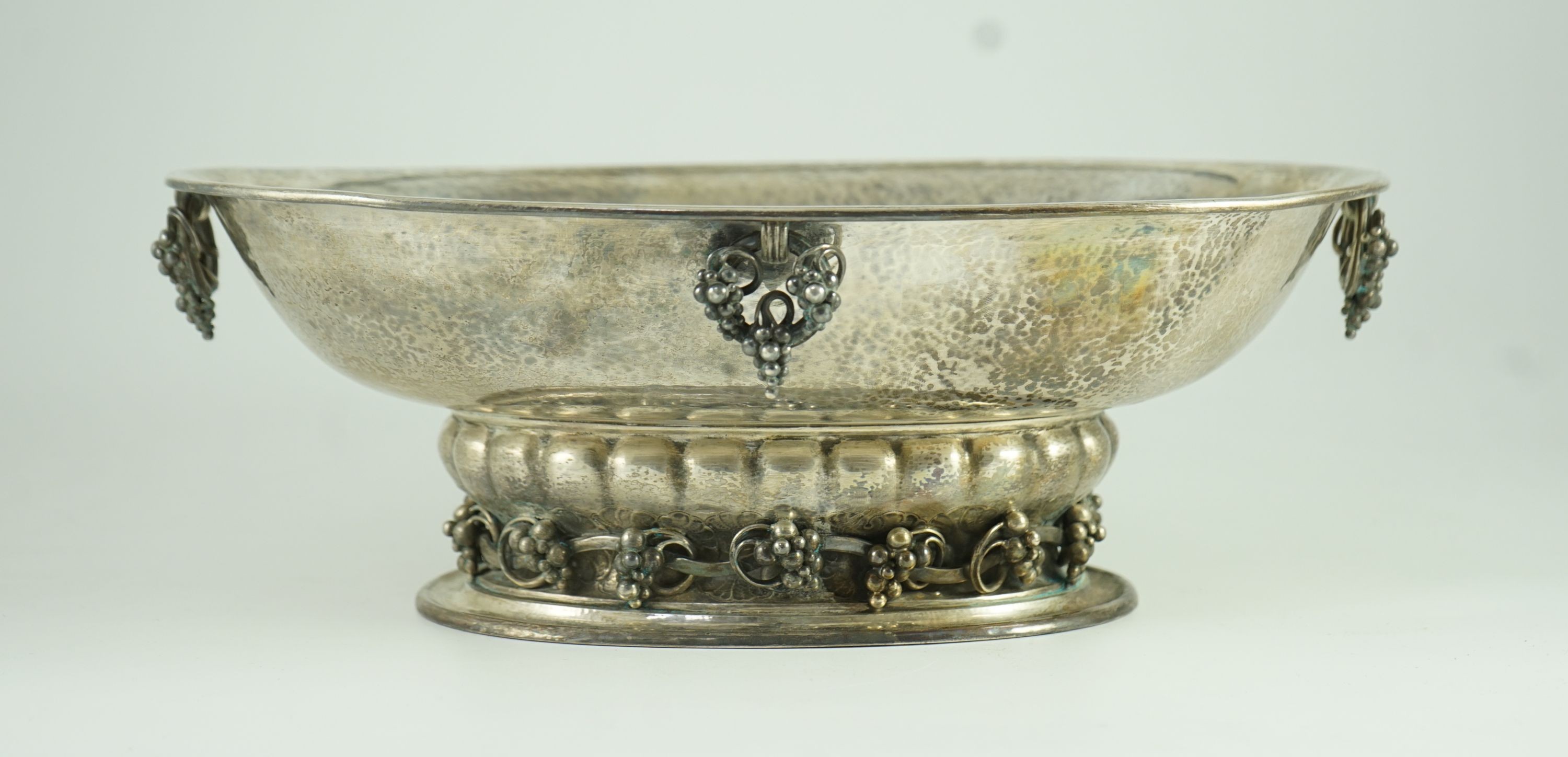 A good George V Georg Jensen planished silver Grape pattern oval pedestal fruit bowl, design no. 296